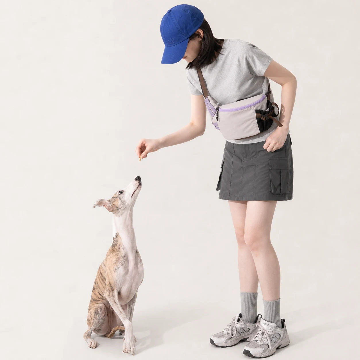 Pawsbetter Everyday Dog Walking Crossbody Bag, lightweight crossbody walking bag with divided storage, training interaction scene