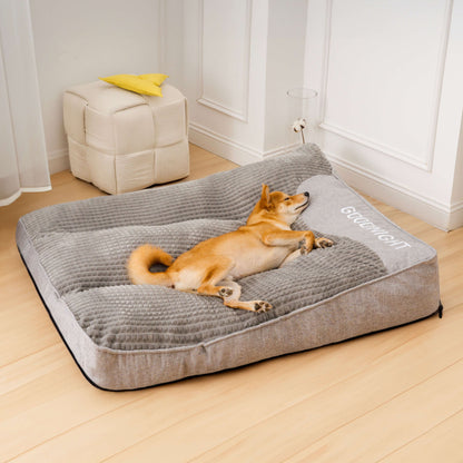 Shiba Inu lounging on a spacious gray orthopedic dog bed