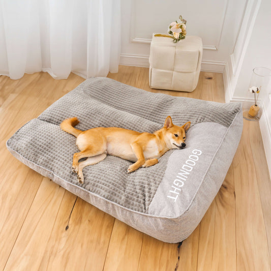 Shiba Inu lying on a large gray orthopedic dog bed